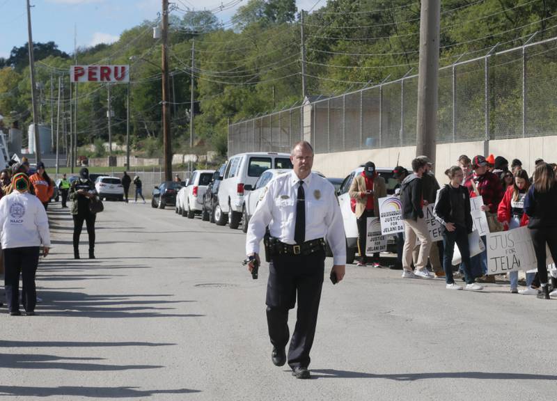 Peru Police Chief Bob Pyszka, walks down Water Street in Peru during the March for Jelani Day in Peru on Tuesday Oct. 26, 2021.