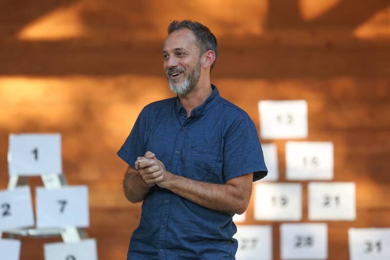 David Hunter, of the GreenRoom Improv, explains the rules for audience participation before the show hosted by the Morris Library at Goold Park on Friday, Aug. 11, 2023 in Morris.