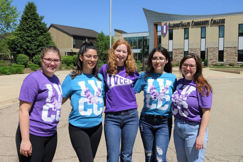 Student workers (from left) Jaclyn Cinotte, Rosy Rocha, Maddison Gentry, Keina Arteaga and Community Relations’ Samantha Manahan show examples of the limited-edition T-shirts that will be given away at Summer Explore IVCC on July 13.