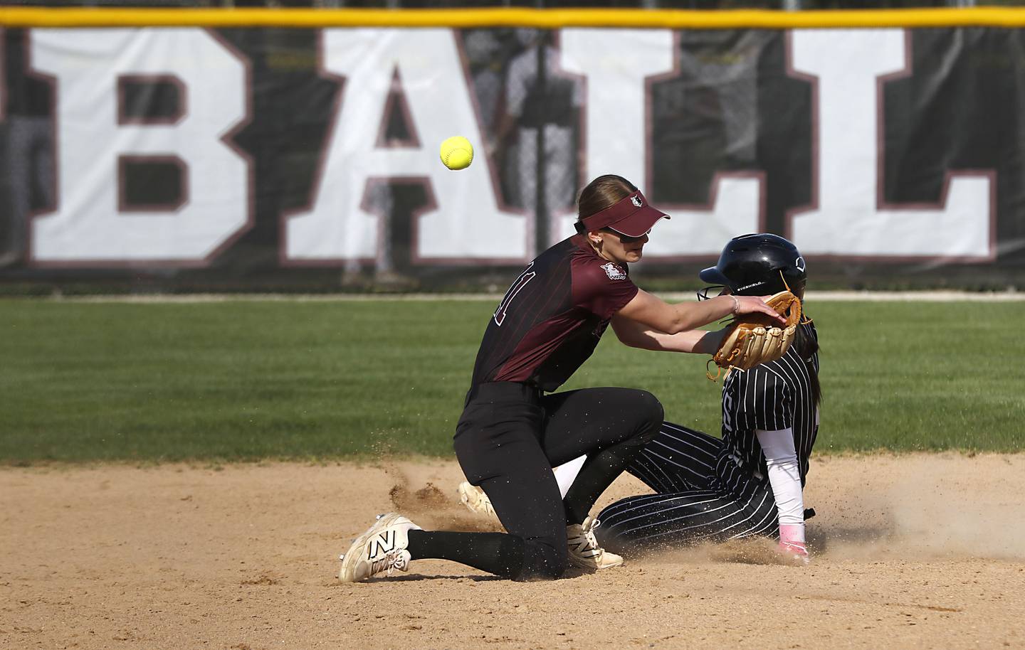 Prairie Ridge's Kylie Carroll tries to field the ball as Crystal Lake Central's Ella Arana slides into second base during a Fox Valley Conference softball game on Monday, April 20, 2026, at Prairie Ridge High School.