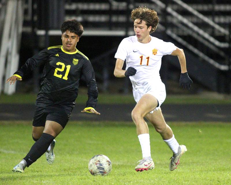 Harvard’s Miguel Fuentes, left, races Richmond-Burton’s Jack Meyer for the ball in varsity soccer on Monday, Oct. 7, 2024, at Dan Horne Field on the campus of Harvard High School in Harvard.