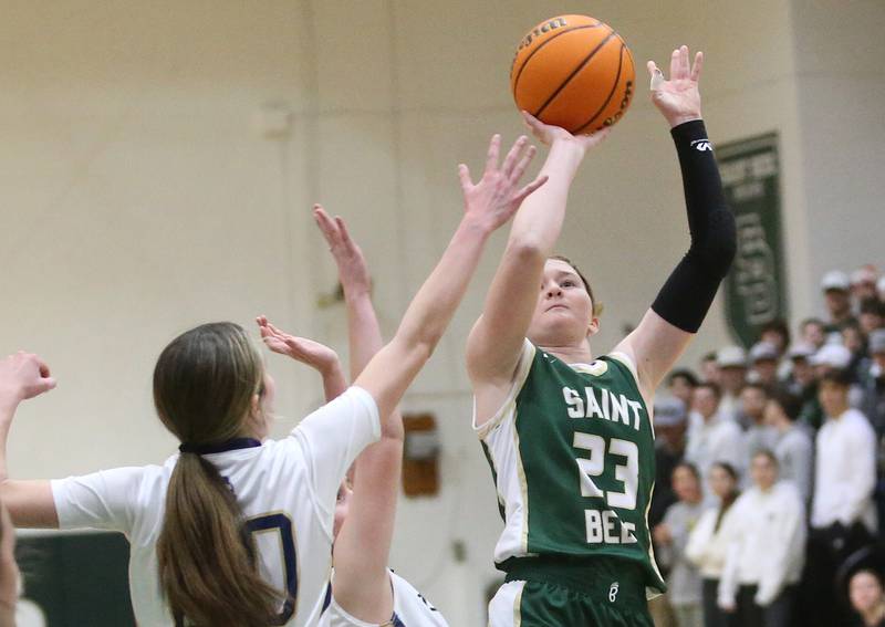 St. Bede's Lili McClain lets go of a jump shot over Marquette's Kaitlyn Davis during the Class 1A Regional semifinal game on Tuesday, Feb. 18, 2025 at St. Bede Academy.