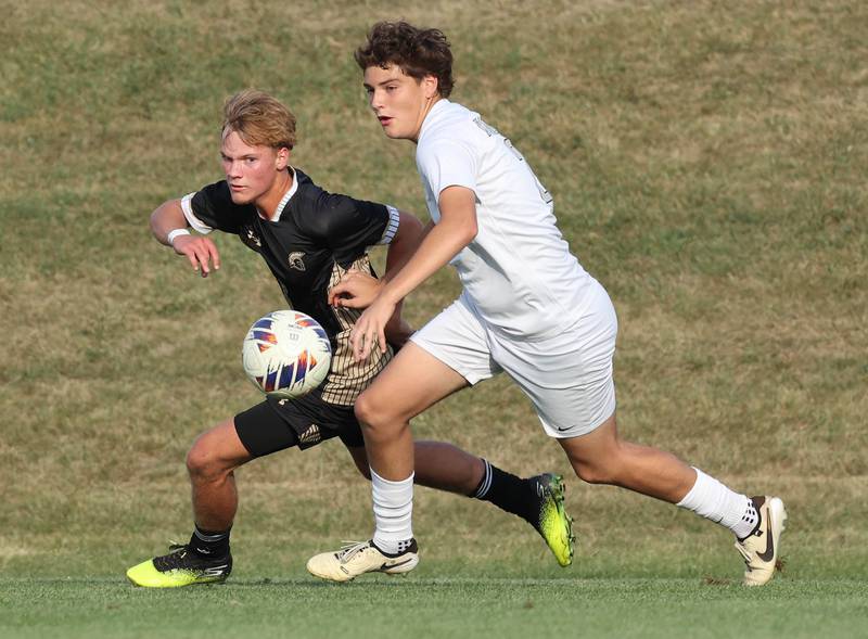 Kaneland's Manny Cepeda (right) tries to hold off Sycamore's Aiden Sears during their game Wednesday, Sept. 18, 2024, at Sycamore High School.