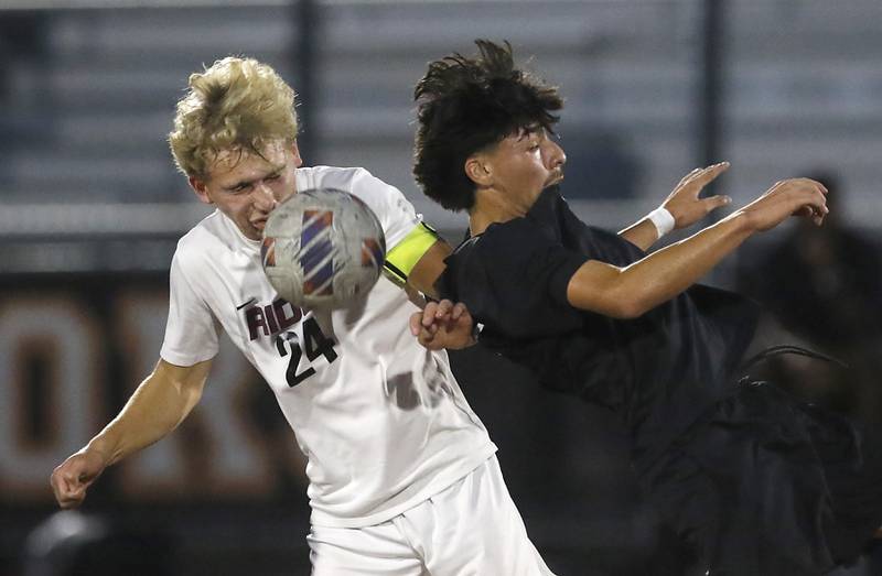 Prairie Ridge's Bryce Schroeder tries to control the ball behind McHenry's Cole Tapia during a Fox Valley Conference boys soccer match on Tuesday, Sept. 30, 2025, at McCracken Field in McHenry.