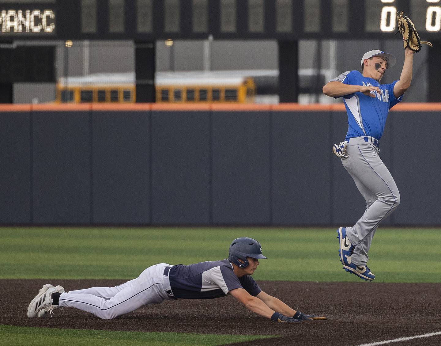 Newman’s Evan Bushman leaps to catch a pick-off throw against Teutopolis’ Davin Worman Friday, June 6, 2025, during the Class 2A state semifinal at Illinois Field in Champaign.