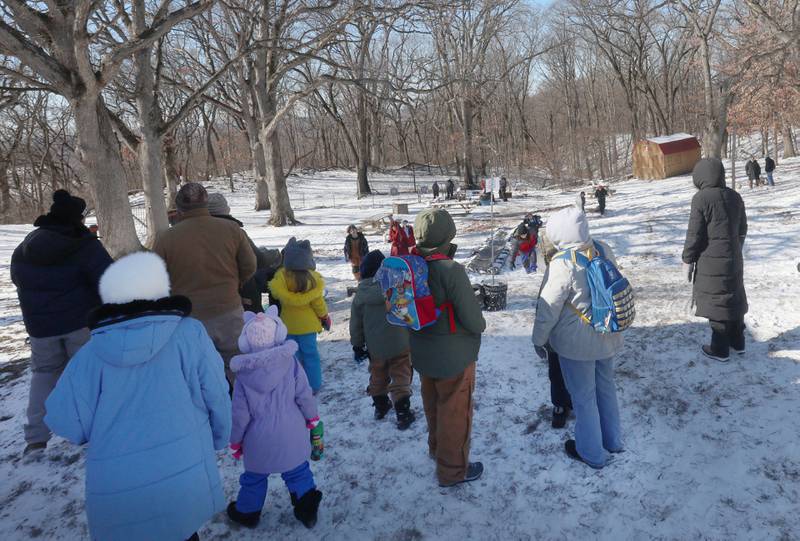 Parents and kids gather near the toboggan run during the Lowaneu Cub Scout Yukon on Saturday, Jan. 31, 2026 at Hall Township Echo Bluff Park in Spring Valley.
