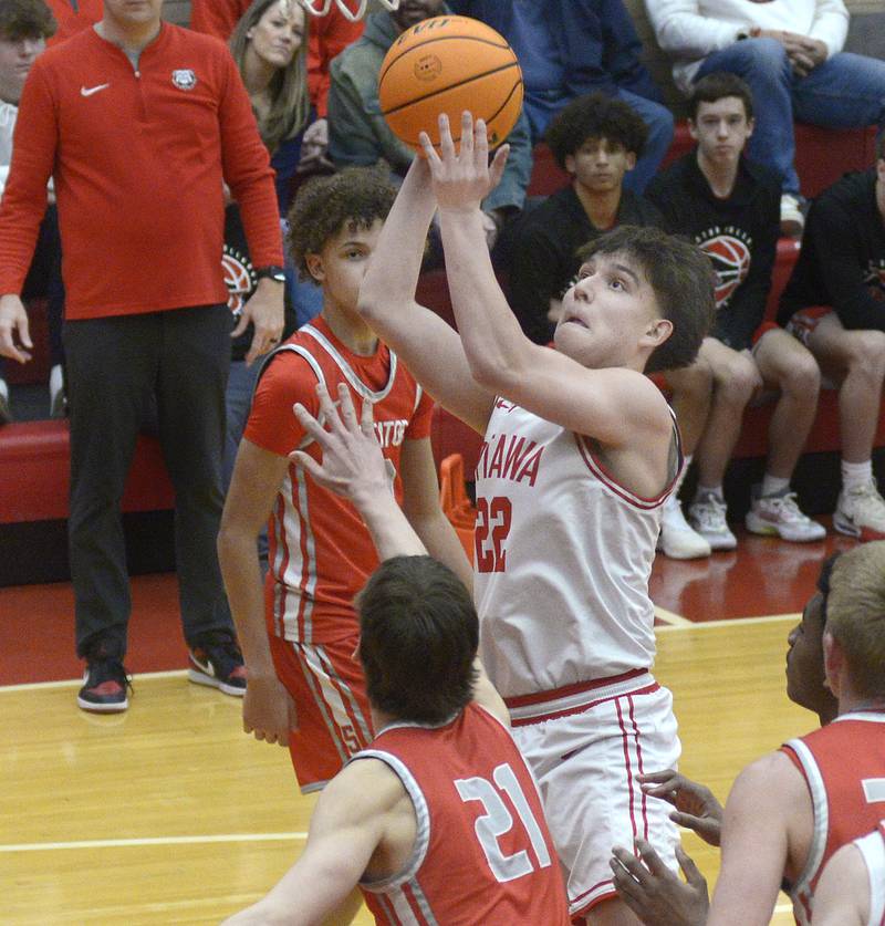 Ottawa’s Dom Parks goes over Streator’s Brennen Stillwell for a layup in the 2nd period Saturday at Ottawa.