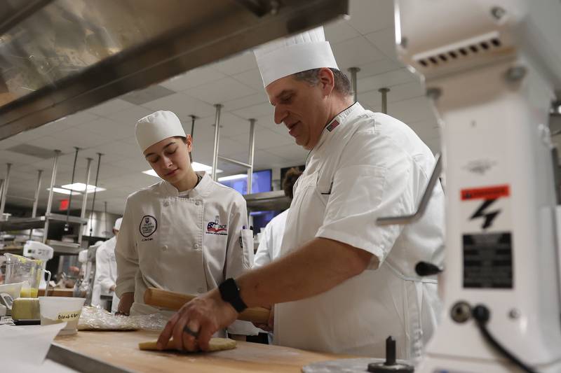Chef Andy Chlebana works student AJ Bertram in one of his pastry classes at the Joliet Junior College City Center Campus on Wednesday, March 1st, 2023. Andy has won numerous awards, including 1st place in two competitive television series on the Food Network.