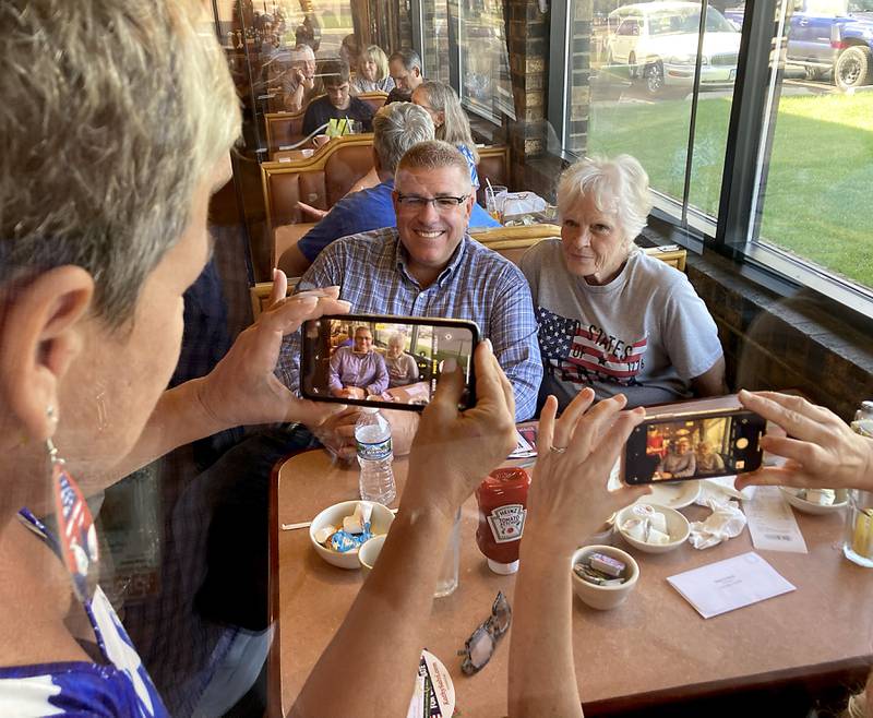 Republican candidate for governor Darren Bailey poses for photographs as he campaigns Wednesday, Sept. 21, 2022, at the Around the Clock Restaurant, 5011 Northwest Highway, in Crystal Lake, during a nine-city bus tour, with Lt. Governor candidate Stephanie Trussell.
