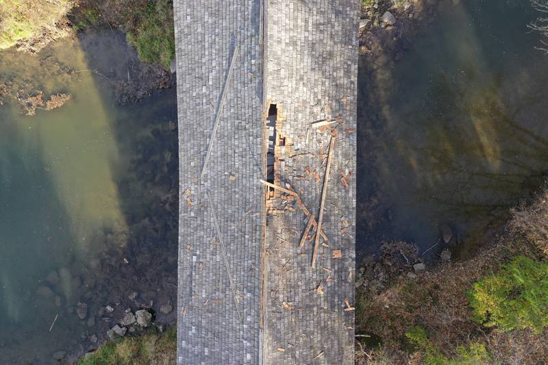 An aerial view of the top of the Red Covered Bridge on Thursday, Nov. 16, 2023 in Princeton. Exposeure to the roof can be seen. Illinois Department of Transportation, Illinois State Police and Bureau County law enforcement surveyed the damage bridge after it was struck by a semi-truck.