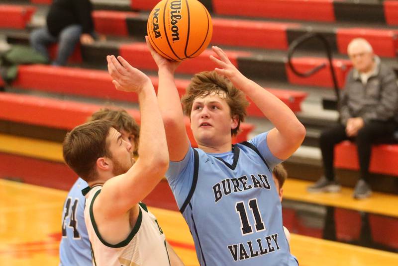 Bureau Valley's Blake Foster eyes the hoop as St. Bede's Mason Ross defends during the 50th annual Colmone Classic on Thursday, Dec. 12, 2024 at Hall High School.