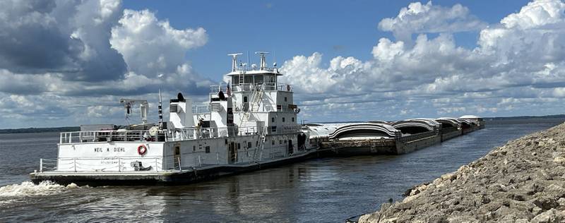 The towboat Neil N Diehl pushes barges up the Mississippi River after passing through Lock & Dam 13 near Fulton on Sunday, July 6, 2025.