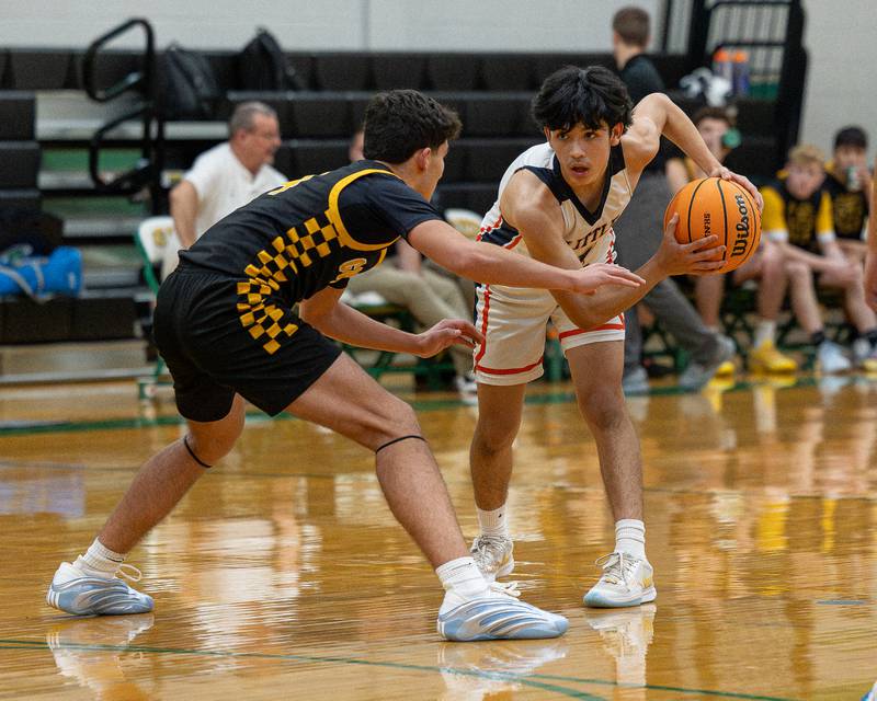 Pedro Lopez (1) of DePue holds ball as Chase Isaac (4) of Reed-Custer guards him during game in the Shipyard Showdown on Tuesday, December 23, 2025 at Seneca High School in Seneca.