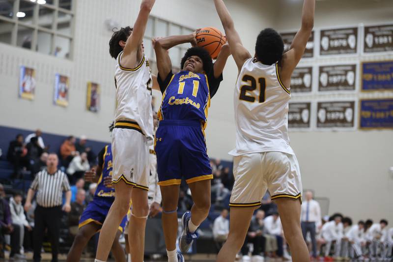 Joliet Central’s Ezekiel Boatright splits the Joliet Catholic defenders for a shot on Tuesday, Jan 20, 2026 in Joliet.