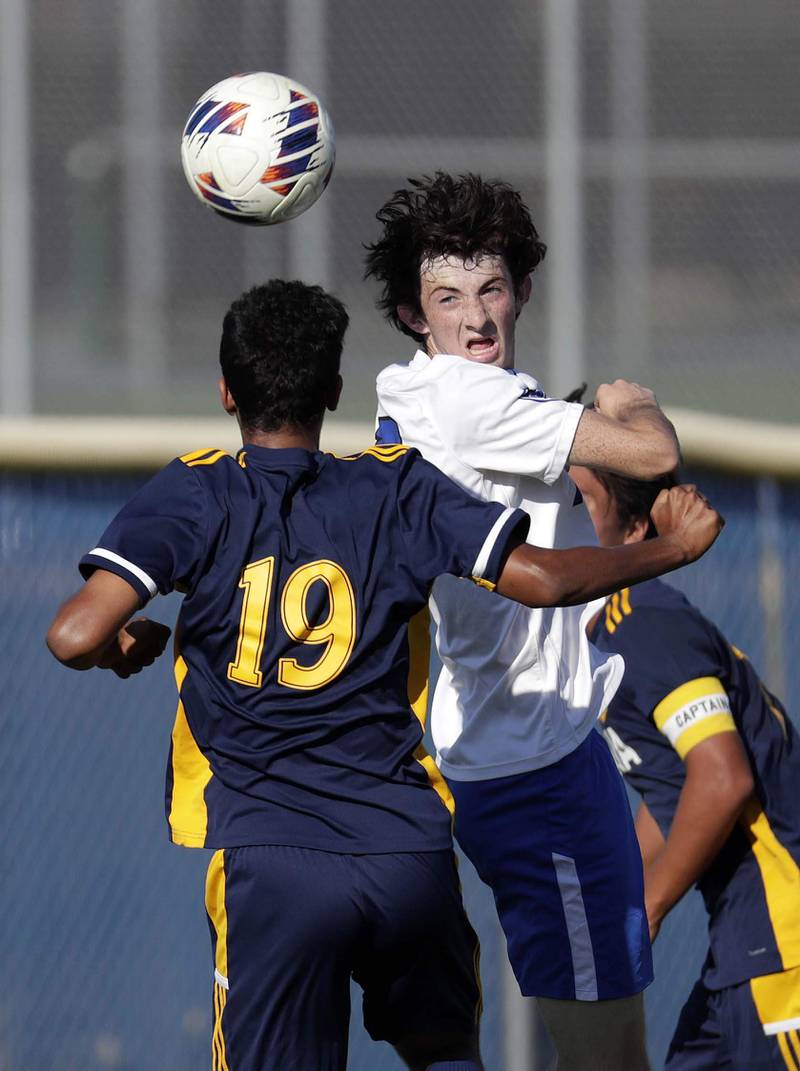 St Charles North's Bryce Thomas (13) heads the ball past Neuqua Valley's Sattam Alharbi (19) Thursday September 8, 2022 in Naperville.