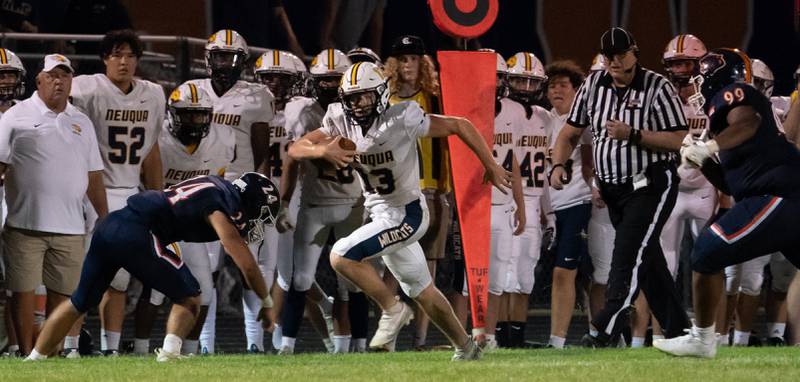 Neuqua Valley's Mark Mennecke (13) carries the ball on a keeper against Oswego during a football game at Oswego High School on Friday, Aug 26, 2022.