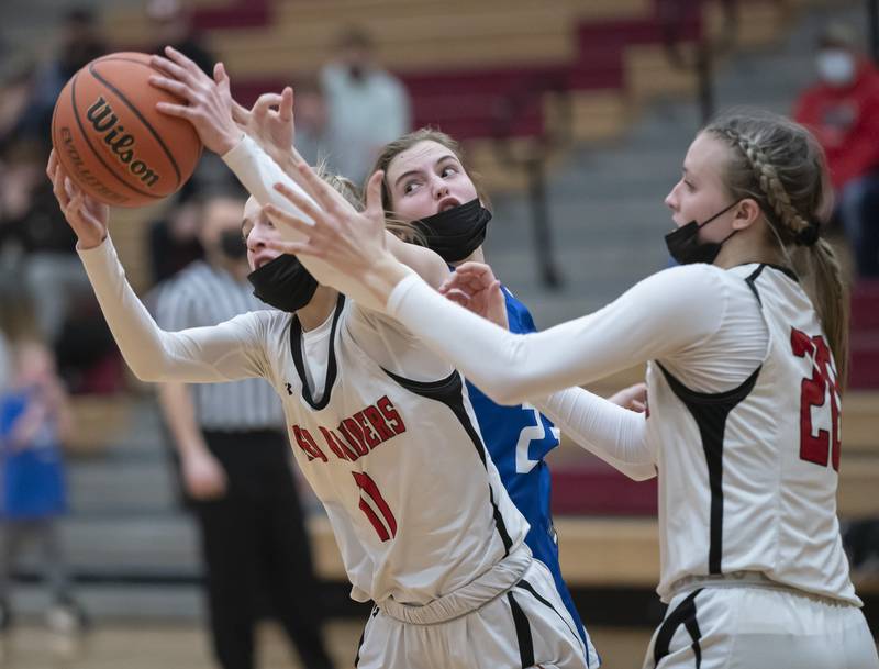 Huntley's Anna Campanelli, left, Jori Heard and Burlington Central's Rylie Duval battle for a rebound under the basket during their game on Saturday, January 29, 2022 at Huntley High School. Huntley won 52-49.