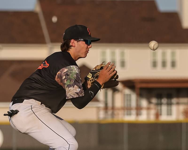 Sandwich's Chase Clark (17) has a grounder take a bad hop during baseball game between Sandwich at Plano.  May 8, 2024