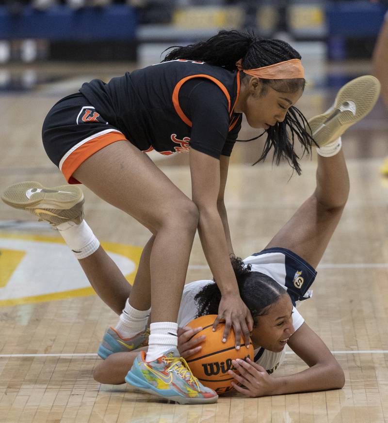 Sterling’s Alivia Gibson fights for a loose ball against United Township’s Reemaz Adam Thursday, Dec. 18, 2025.