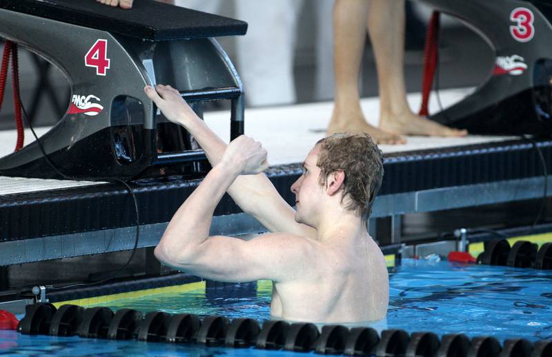 Lyons Township’s Jack Wanless celebrates his win in the consolation heat of the 100-yard freestyle during the IHSA Boys Swimming and Diving Championships at FMC Natatorium in Westmont on Saturday, Feb. 26. 2022.