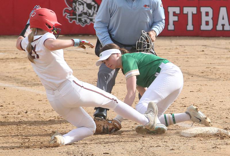 Ottawa's Piper Lewis slides safely into third base as Seneca's Kaylee Klinker misses the tag on Friday, May 2, 2025 at Ottawa High School.