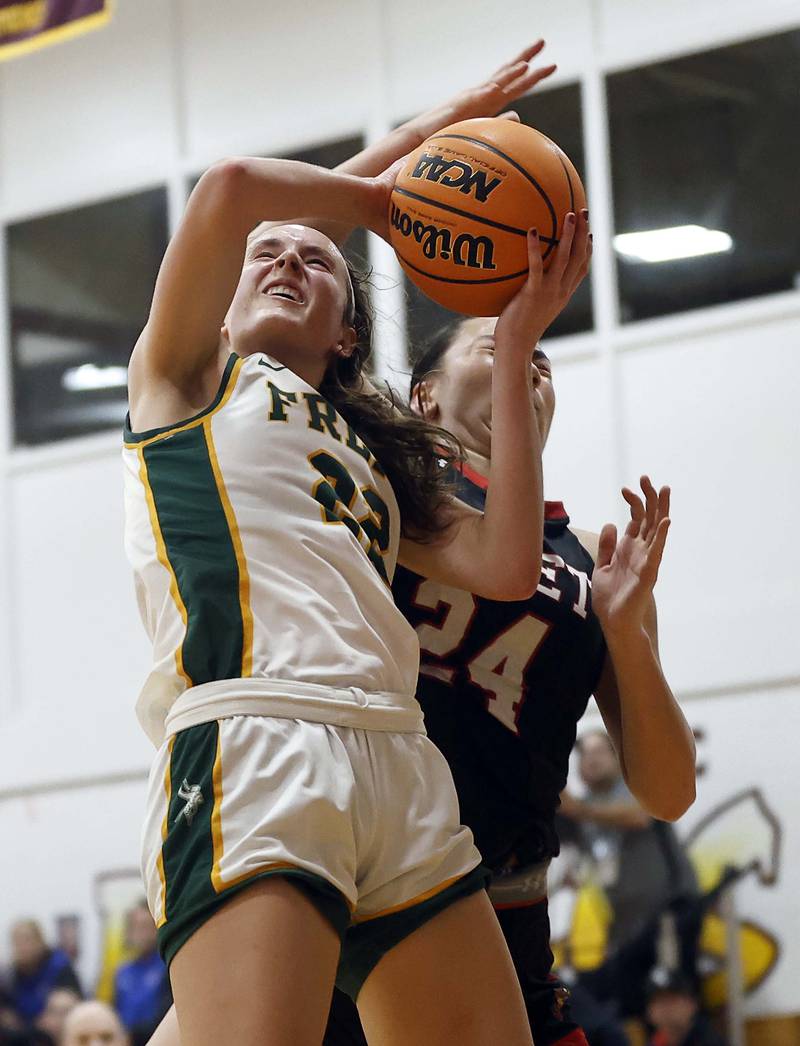 Fremd’s Ella Todd (22) is fouled by Benet Academy's Emma Briggs (24) on a fast break during the Montini girls basketball Christmas tournament Saturday, Dec. 28, 2024 in Lombard.