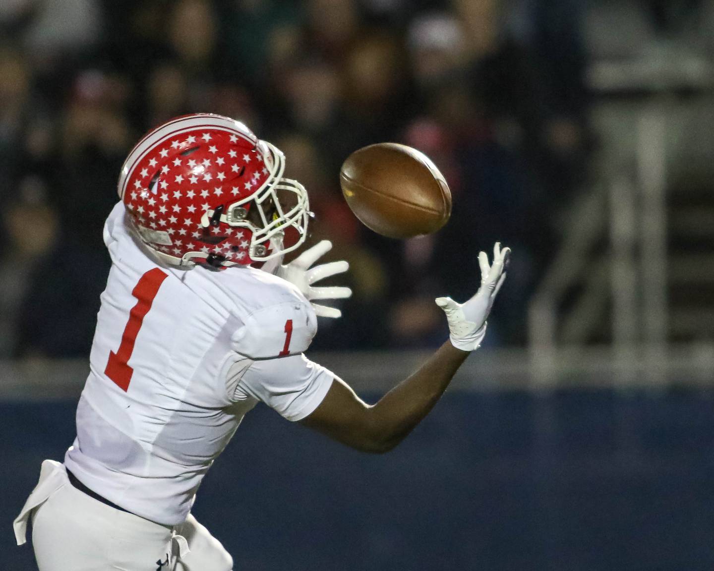 Naperville Central's DeShaun Williams (1) catches a pass over the middle and ran it in for a touchdown during Class 8A quarterfinal football game between Naperville Central at Lyons on Friday, Nov 15, 2024  in Western Springs.