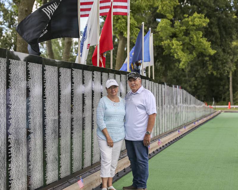 Wayne Horne who fought in the 101st Airborne division, poses with his wife at the Vietnam Traveling Memorial Wall Thursday, Aug 21, 2025  in Romeoville.