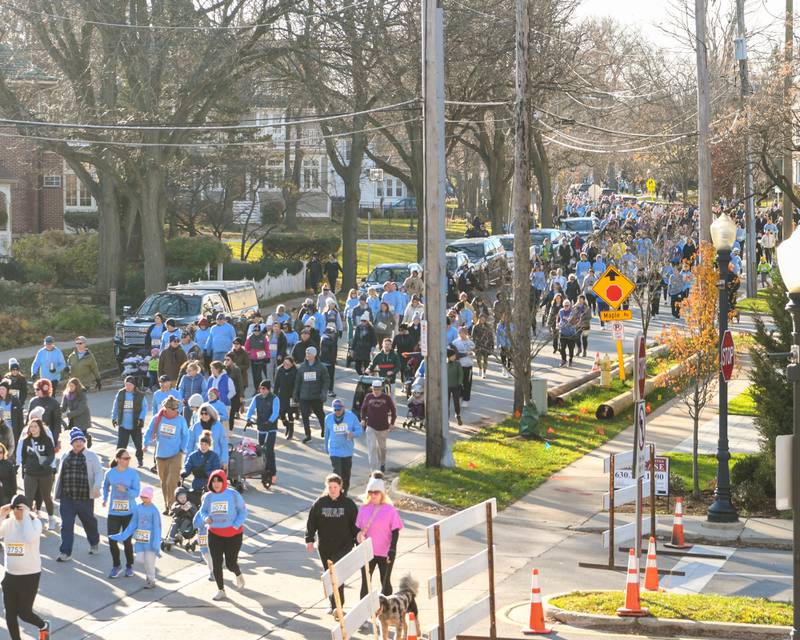 More than 6,160 participants line the streets in downtown Downers Grove to participate in the Grove Express 5k on Thursday Nov 23, 2023.