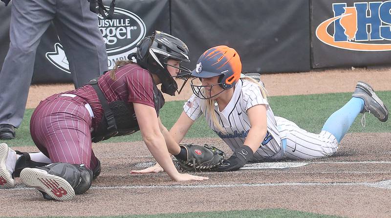 Oak Park River Forest's Maura Carmody dives safely across home plate as Lockport catcher Liliana Janeczko misses the tag during the Class 4A third-place game on Saturday, June 14, 2025 at the Louisville Slugger Sports Complex in Peoria.