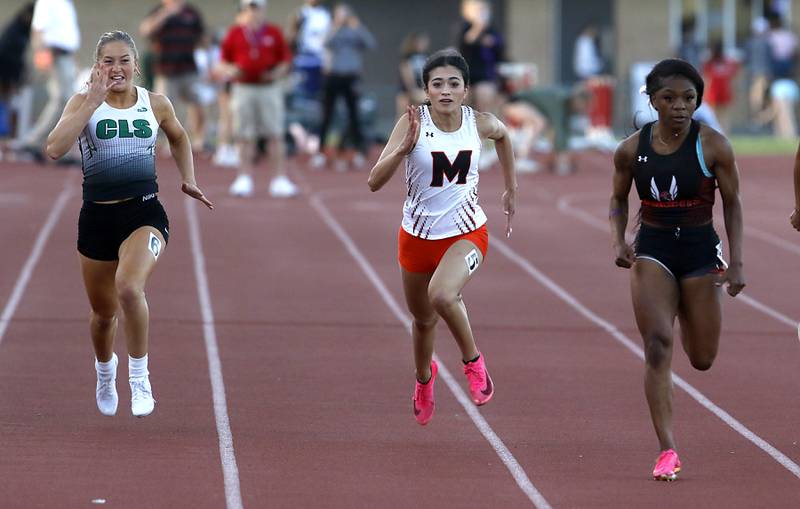 Crystal Lake South’s Gracey Lepage and McHenry’s Kelly Huerta try to catch Rockford Auburn’s Essence Horton-Graves in the 100 meter dash during the Huntley IHSA Class 3A Girls Sectional Track and Field Meet on Wednesday, May 8, 2024, at Huntley High School.