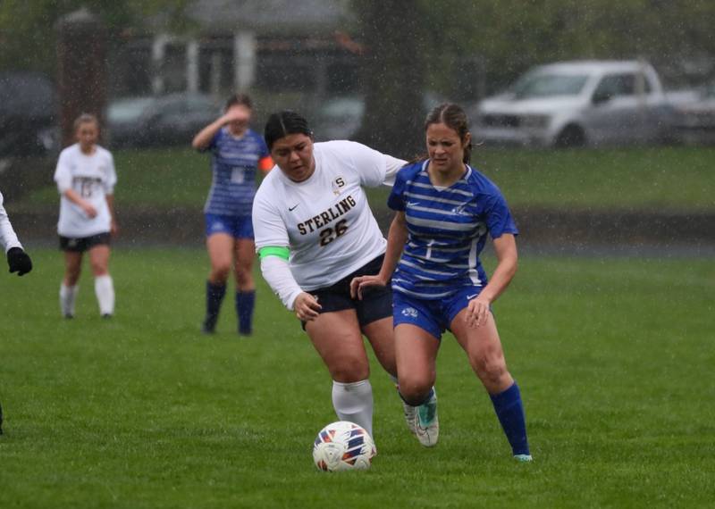 Princeton's Olivia Sandoval battles Sterling's Michelle Diaz (26) for the ball Thursday at Bryant Field. The Tigresses prevailed over the Golden Warriors and rain for a 3-1 victory.