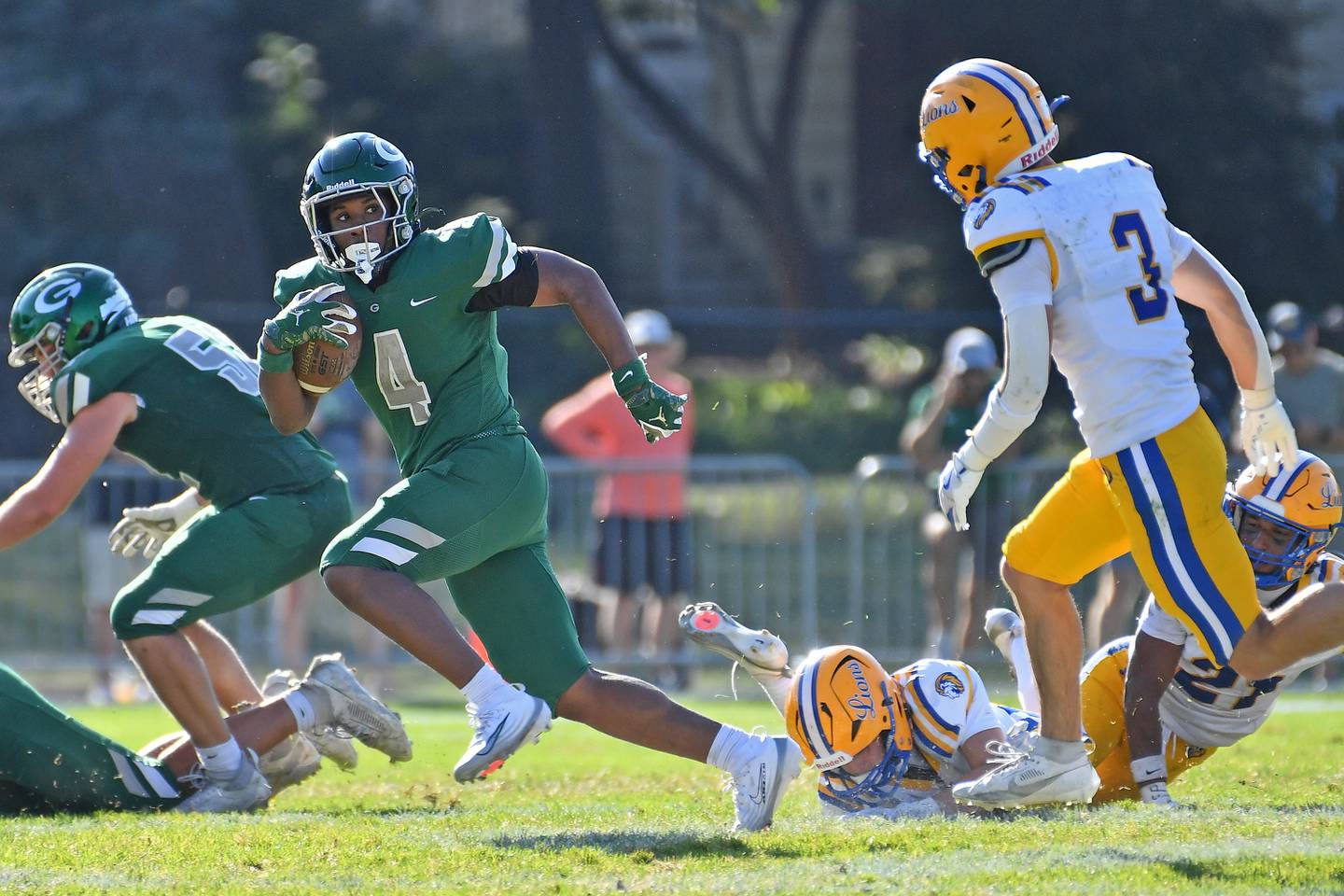 Glenbard West’s Jamarcus Kelly (4) breaks away for a long touchdown leaving Lyons Township defenders in his wake during a game on September 27, 2025 at Glenbard West High School in Glen Ellyn.