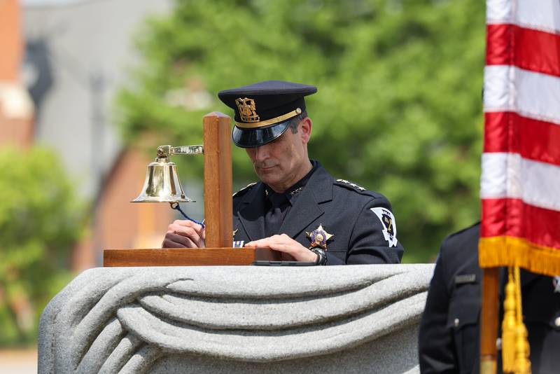 Kankakee Police Chief Chris Kidwell rings the bell as the roll call of fallen officers is read during the annual Law Enforcement Officers Memorial Ceremony honoring Kankakee County officers, held on the lawn of the Kankakee County Courthouse on Thursday, May 15, 2025.