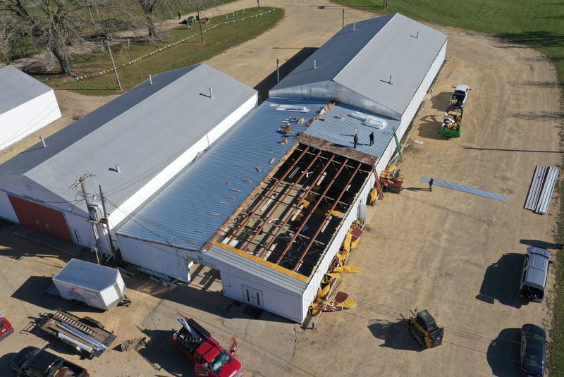 Crews from Vitale Construction work on replacing the roof of the exterior of the Exhibit Hall's 1 and 2 building on Wednesday, Nov. 8, 2023 at the Bureau County Fairgrounds in Princeton.