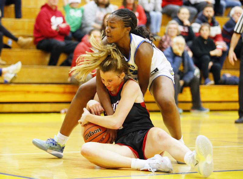 Lyons' Nora Ezike (25) fights for the ball against Lyons' Lenee Beaumont (5) during the girls varsity basketball game between Benet Academy and Lyons Township on Wednesday, Nov. 30, 2022 in LaGrange, IL.