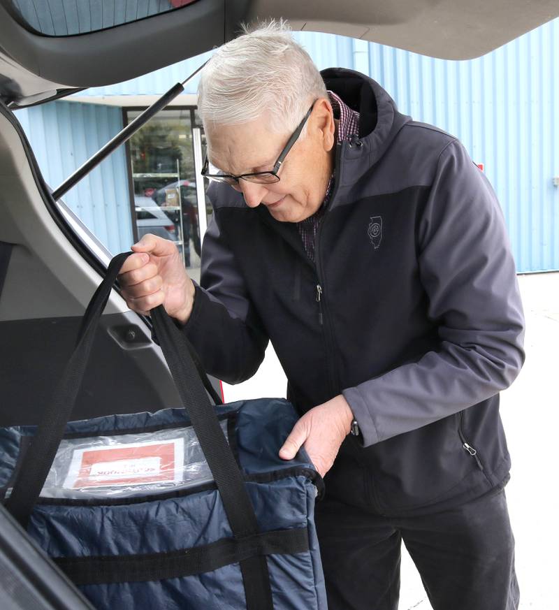 Volunteer Tom Webber loads up a van with a Meals on Wheels delivery Tuesday, April 23, 2024, at the Voluntary Action Center in Sycamore. VAC is celebrating its 50th anniversary this year.