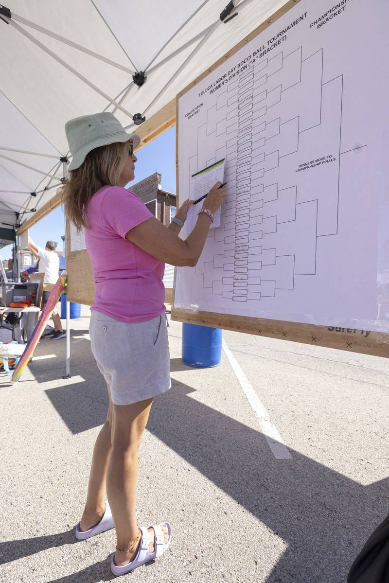 Gina Rolinski-Pomatto prepares the woman's tournament bracket at the Chuck Rolinski's Labor Day Bocce Tournament in Toluca on September 1, 2024.