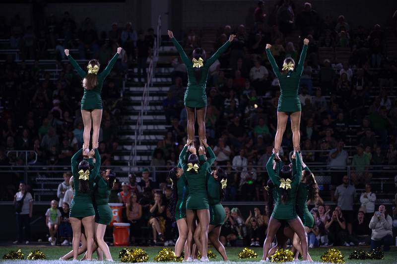 Bishop McNamara cheerleaders lead the crowd in a cheer in a game against Chicago Christian on Friday, September 19, 2025.