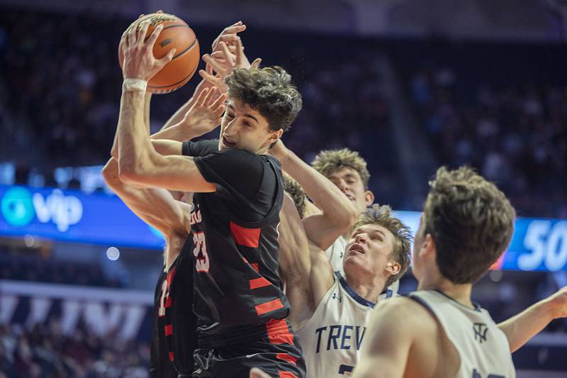 Benet Academy’s Niko Abusara (23) pulls down an offensive rebound against New Trier on Friday, March 10, 2023, during the Class 4A IHSA state semifinals.
