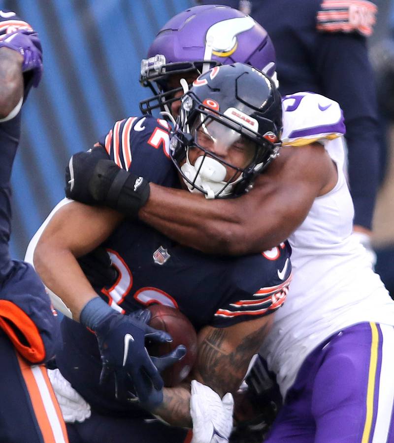 Chicago Bears running back David Montgomery is wrapped up by Minnesota Vikings linebacker Danielle Hunter Sunday, Jan. 8, 2023, during their game at Soldier Field in Chicago.