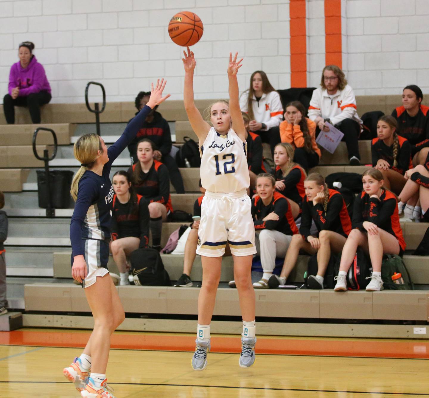Marquette's Lilly Craig shoots a three point shot over Fieldcrest's Kaitlyn White during the Integrated Seed Lady falcon Basketball Classic tournament on Monday, Nov. 13, 2023 at Flanagan High School.