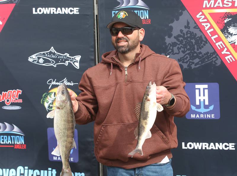 Corey Blair of Utica, holds his catch during the annual Masters Walleye Circuit tournament on Friday, March 21, 2025 at the Spring Valley Boat Club.