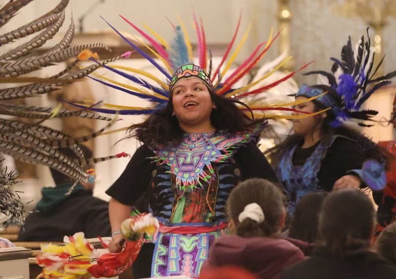 Natalie Mejíia smiles while dancing during the Lady of Guadalupe vigil Chichimeca dance at St. Patrick's Catholic Church on Thursday, Dec. 12, 2025 in La Salle.