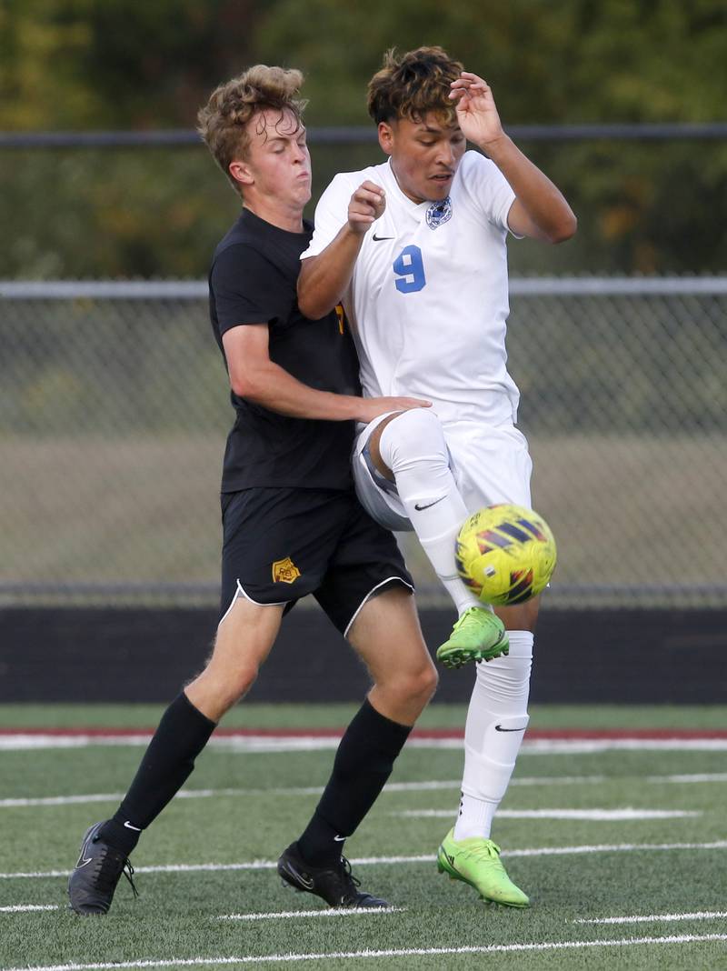 Woodstock's Eric Jacinto tries to control the ball in front of Richmond-Burton’s Nate Larsen during a Kishwaukee River Conference soccer match on Wednesday, Sept. 10, 2025, at Richmond-Burton High School, in Richmond.