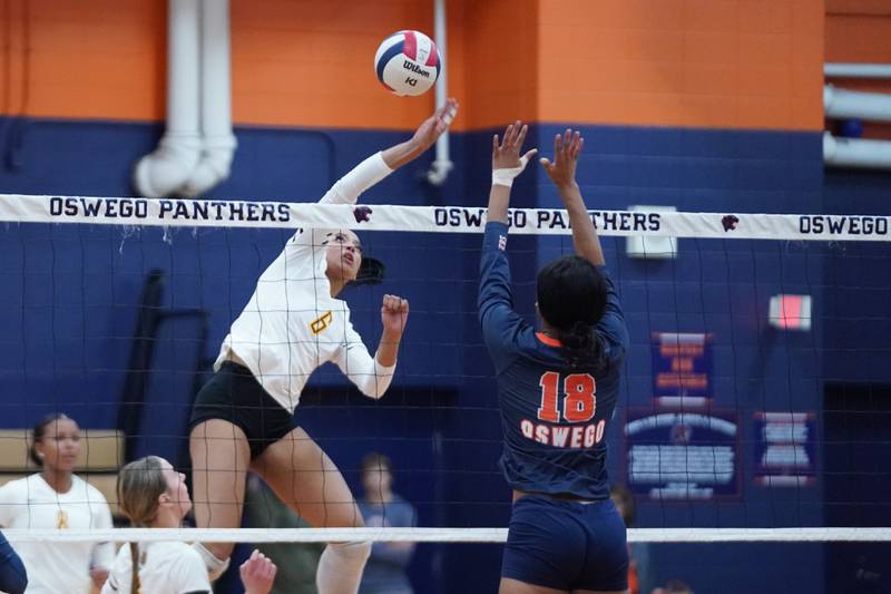 Joliet West's Faith Jordan (6) goes up for a kill attempt against Oswego’s Maya Norlin (18) during a volleyball match at Oswego High School on Thursday, October 24, 2024.
