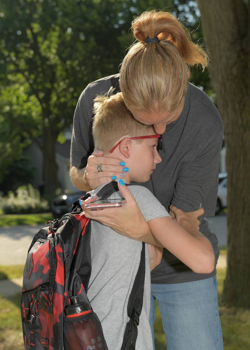 Valerie Fisk hugs her son Danny, 8 as she sends him off to school at Davis Elementary in St. Charles on Wednesday, Aug 13, 2025.