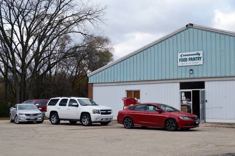 A line of cars wait outside the Dixon Community Food Pantry on Friday, Nov. 10, 2023. Guests wait in their vehicles while the items on their shopping lists are gathered and brought out to them.