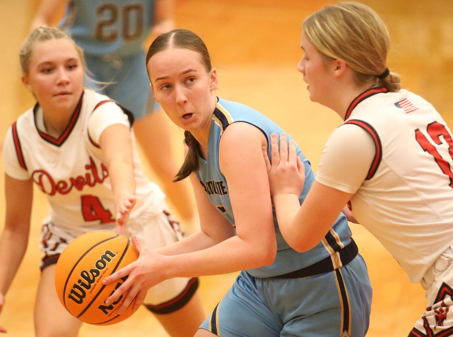Marquette's Chloe Larson looks to pass the ball between Hall defenders Charlie Pellegrini and Leah Pelka on Thursday, Feb. 13, 2025 at Hall High School.