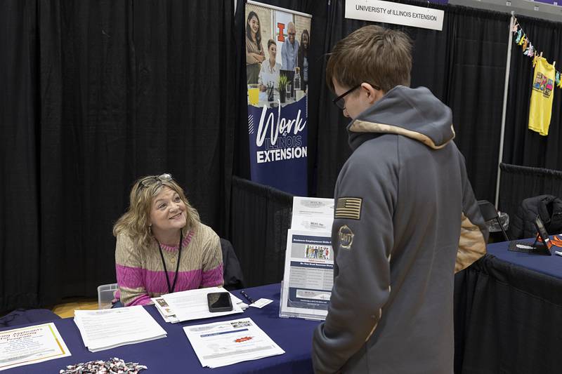 Sally Hanrahan, Best Inc. representative, speaks to a visitor Wednesday, March 11, 2026, during Discover Dixon’s career fair.